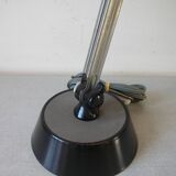 Super Chrome old articulated metal desk lamp on workshop decor base
