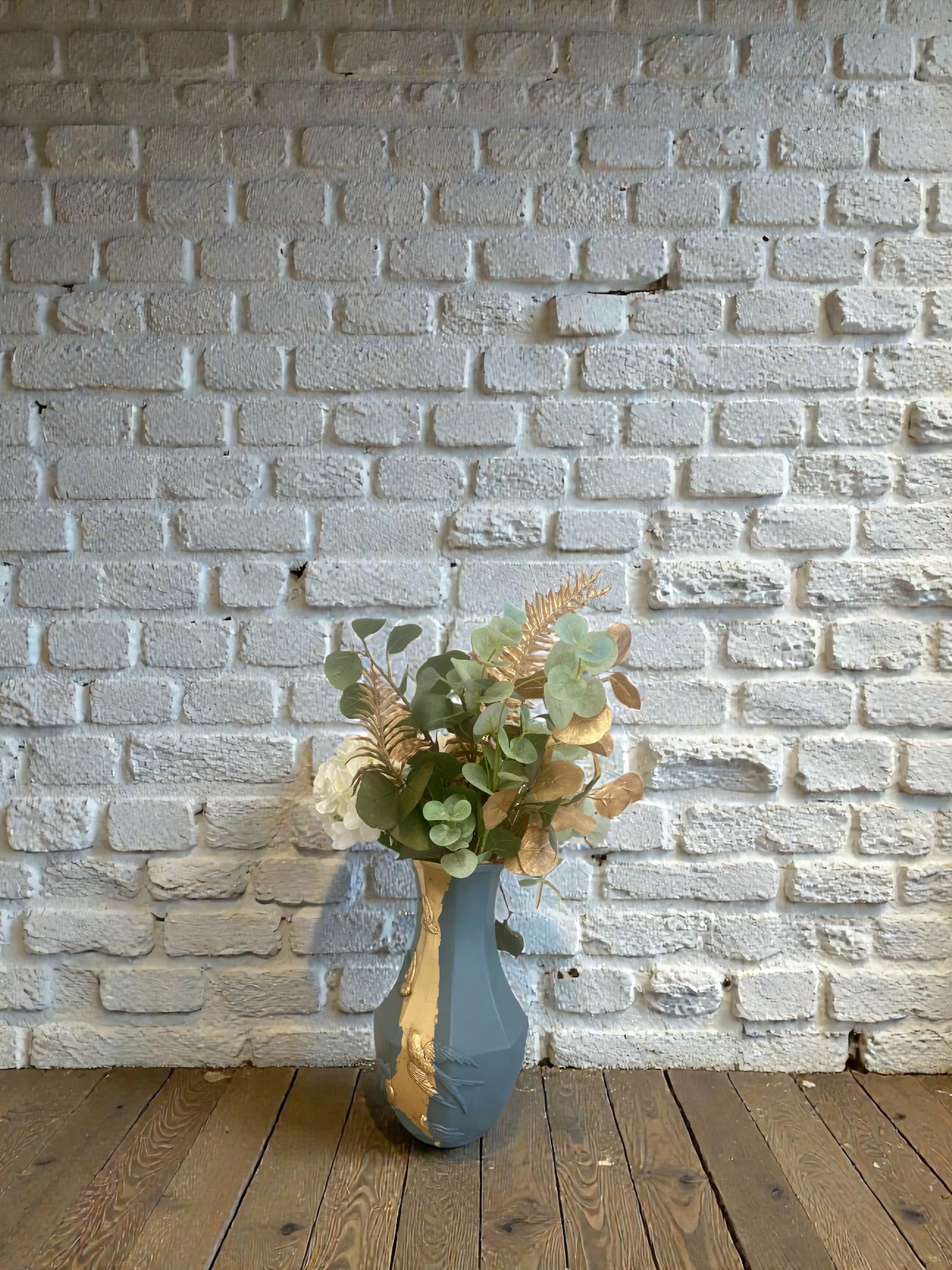 Large decorative blue-grey pitcher with swallow mouldings and gold leaf.
