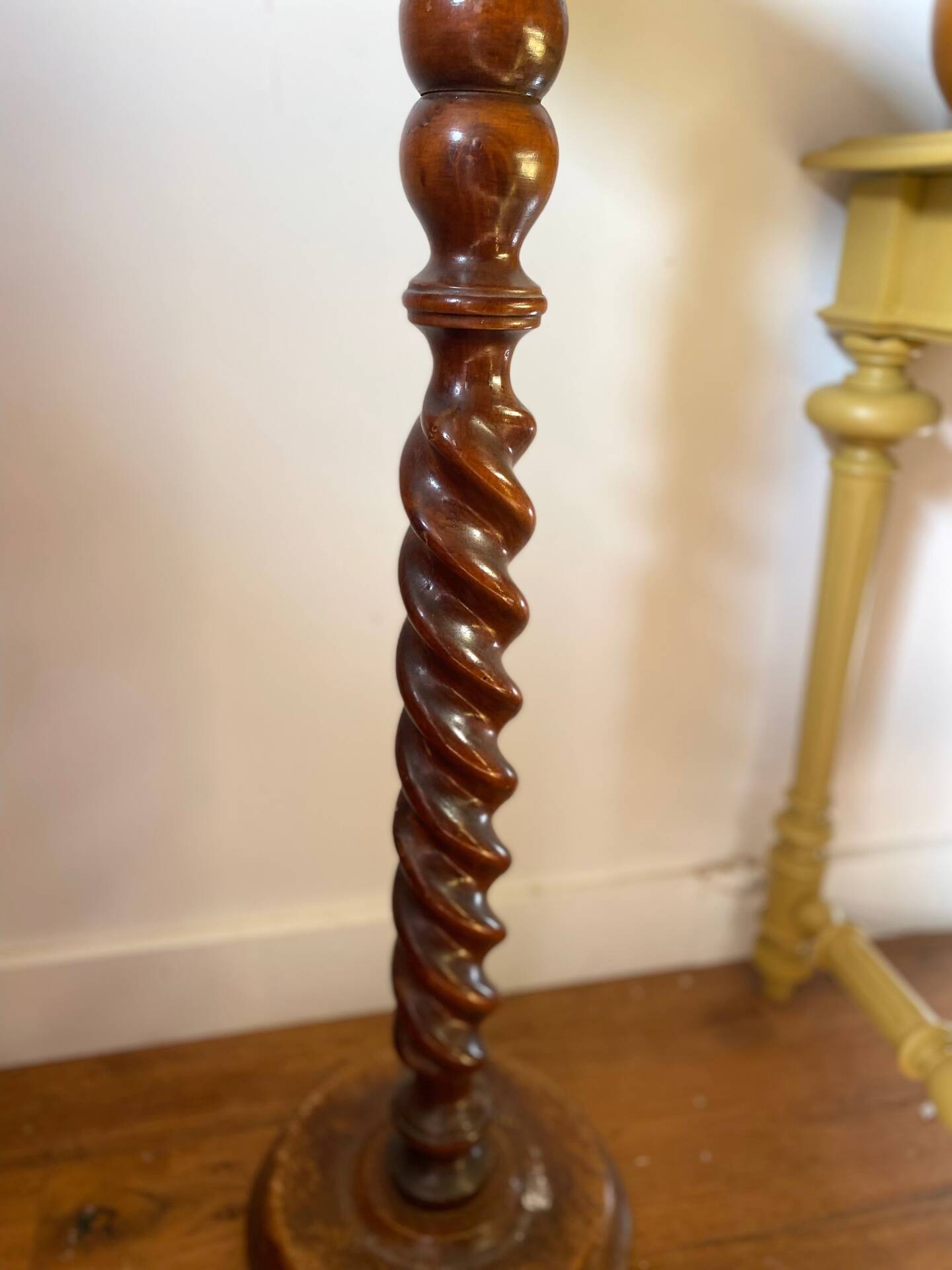 Antique pedestal table with a twisted column.