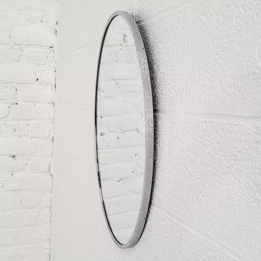 Oval mirror from the 1960s with a chrome frame.