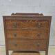 Antique chest of drawers on wheels with wood carving (key top drawer)