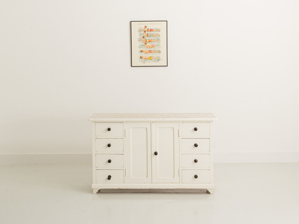 Small accent cabinet with drawers and swing doors