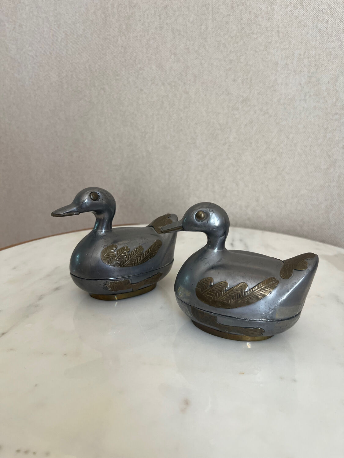 Pair of vintage decorative metal boxes in silver, shaped like ducks.