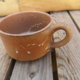 Brown sandstone cup with white spots