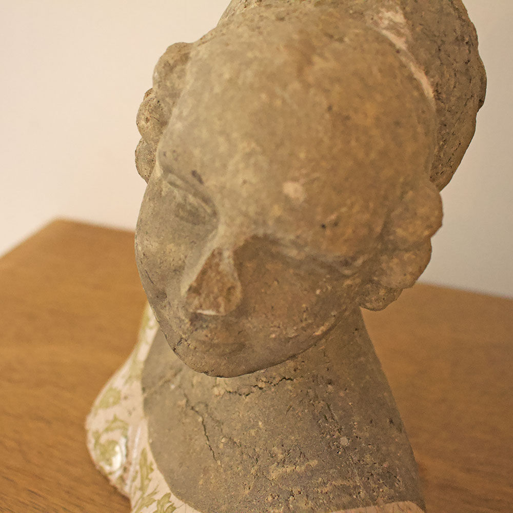 Woman bust in stone and enamel