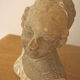 Woman bust in stone and enamel