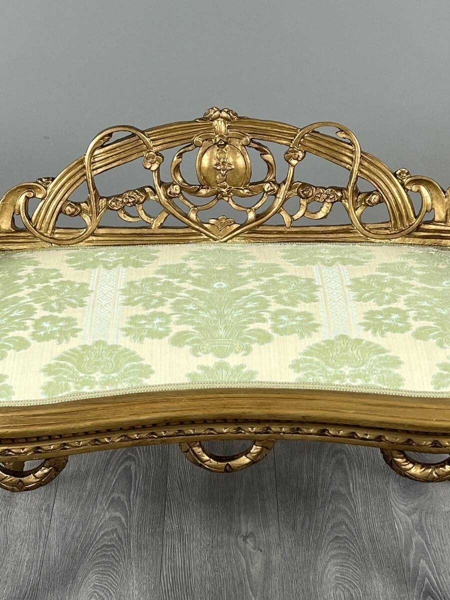 Louis XV style bench in carved and gilded wood, 20th century.