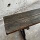 Dark brown wood and black cast-iron antique garden bench with weathered solid-wood seat