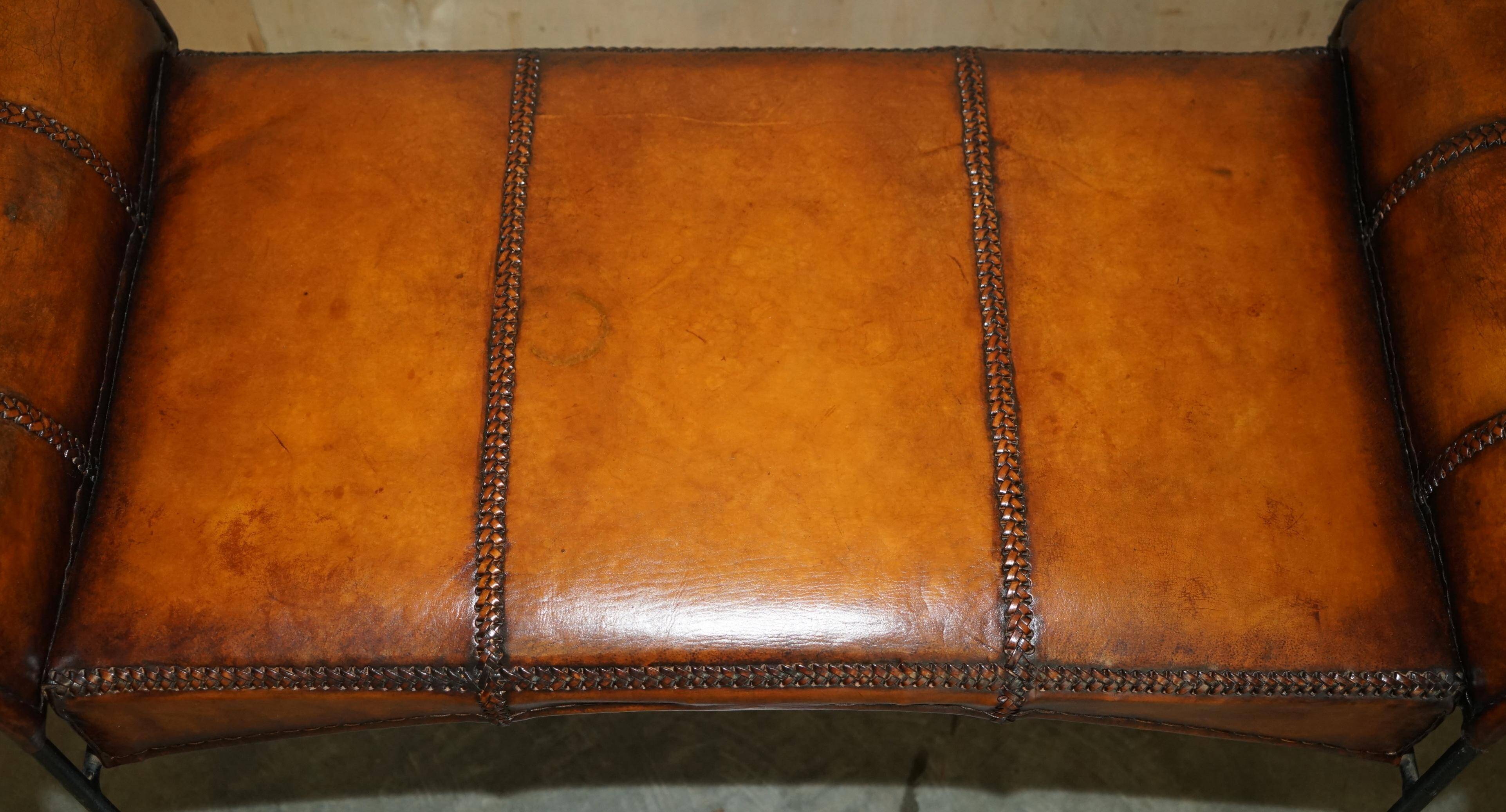 Vintage Spanish window bench in hand-stitched leather and restored iron.