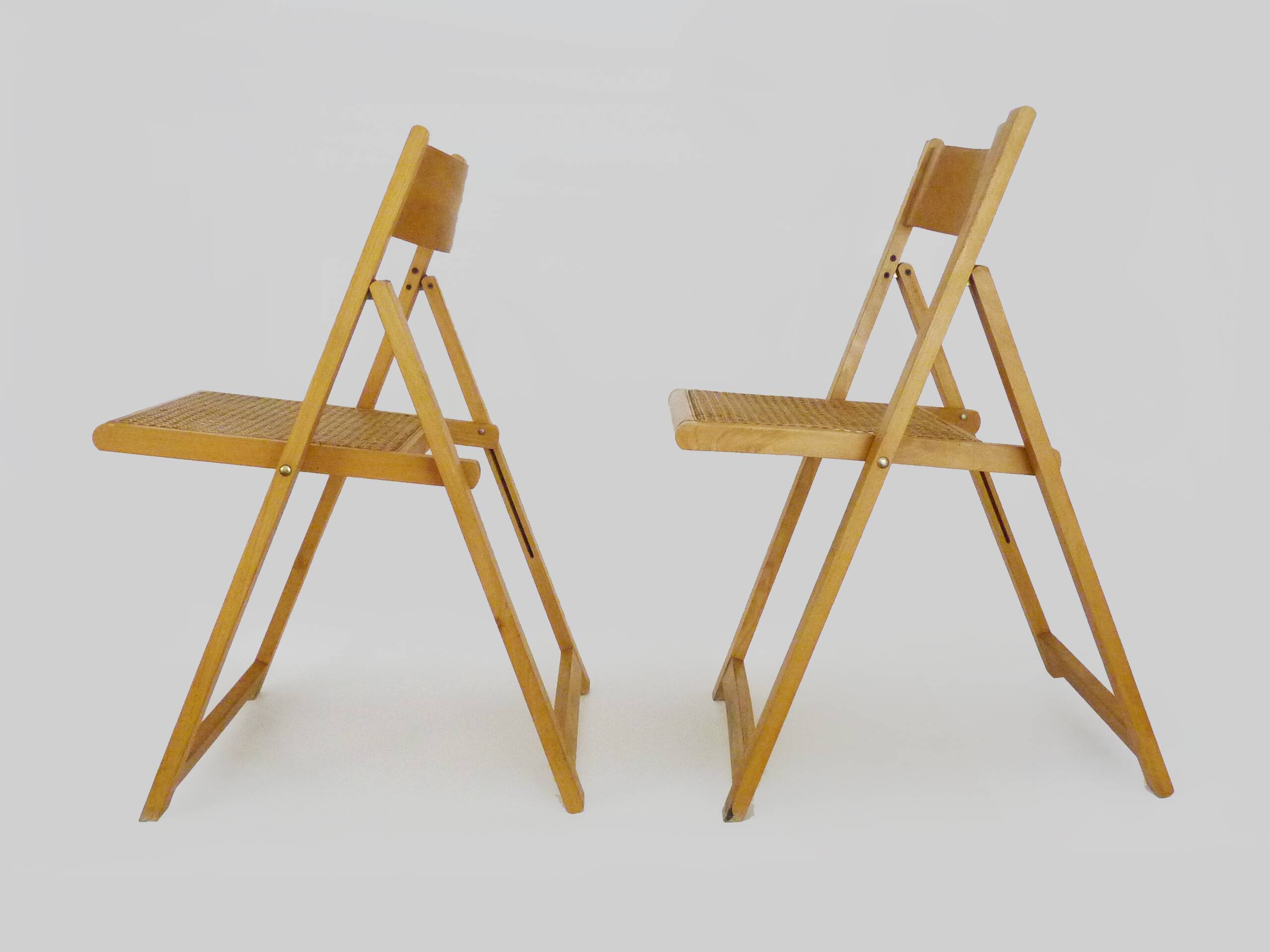 Pair of vintage folding chairs in beech and canework. Italy 70s