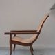 Fauteuil avec assise en cannage et accoudoirs pivotants