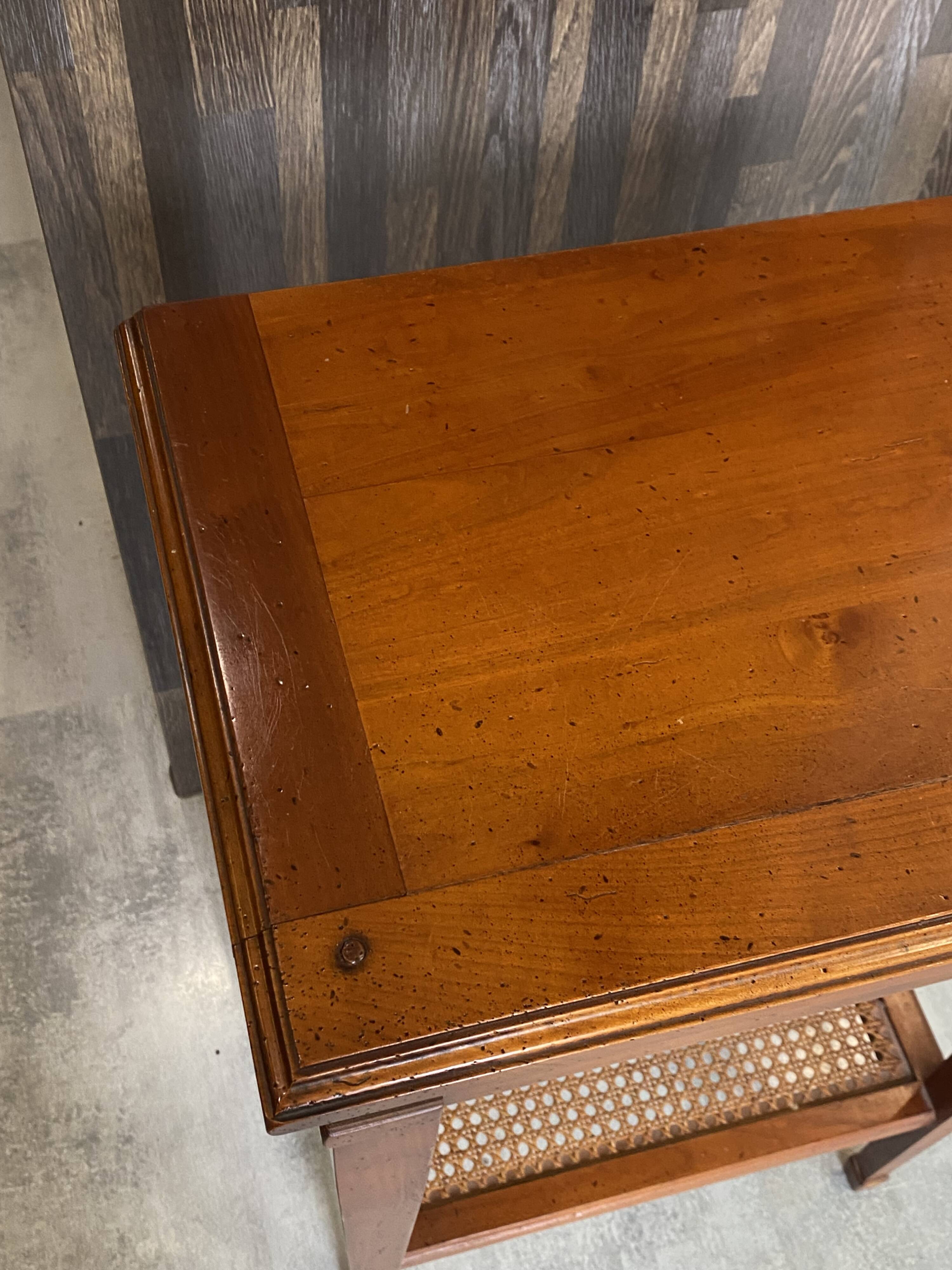 Occasional table in cherry wood, 1 drawer, 1 cane shelf, 1950.