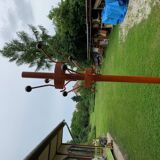 Vintage red industrial coat rack in cast iron, 1950s style, tripod base.