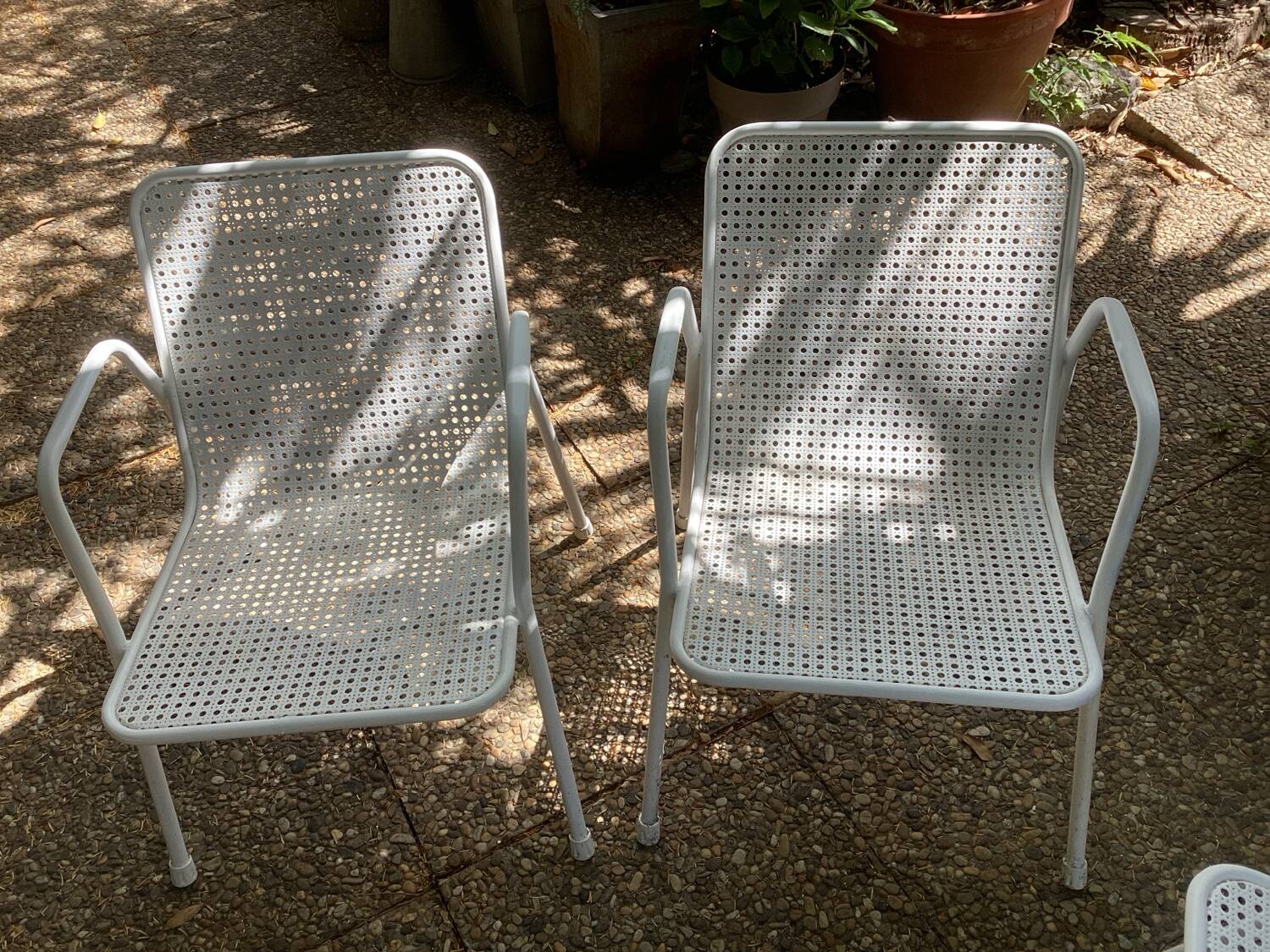 Perforated metal armchairs