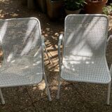 Perforated metal armchairs