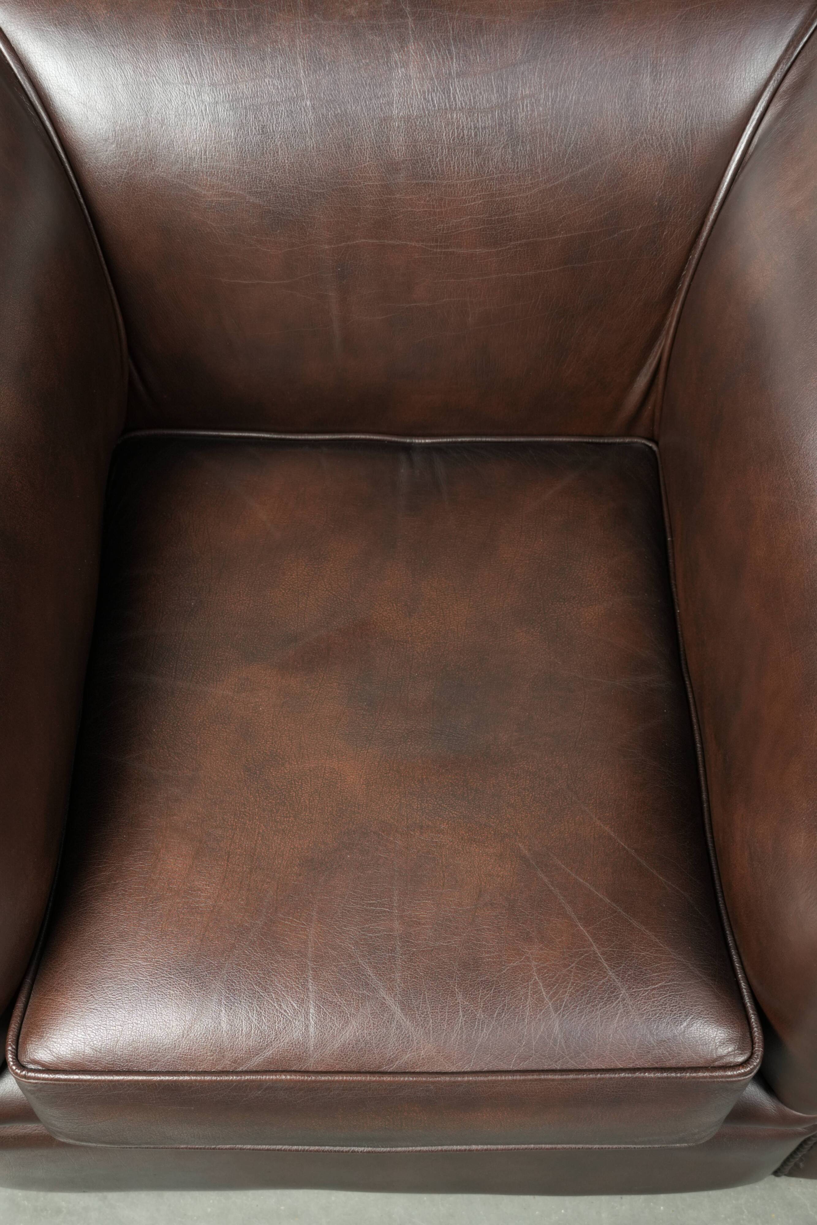 Set of a smooth chesterfield sofa and armchair with a timeless English look