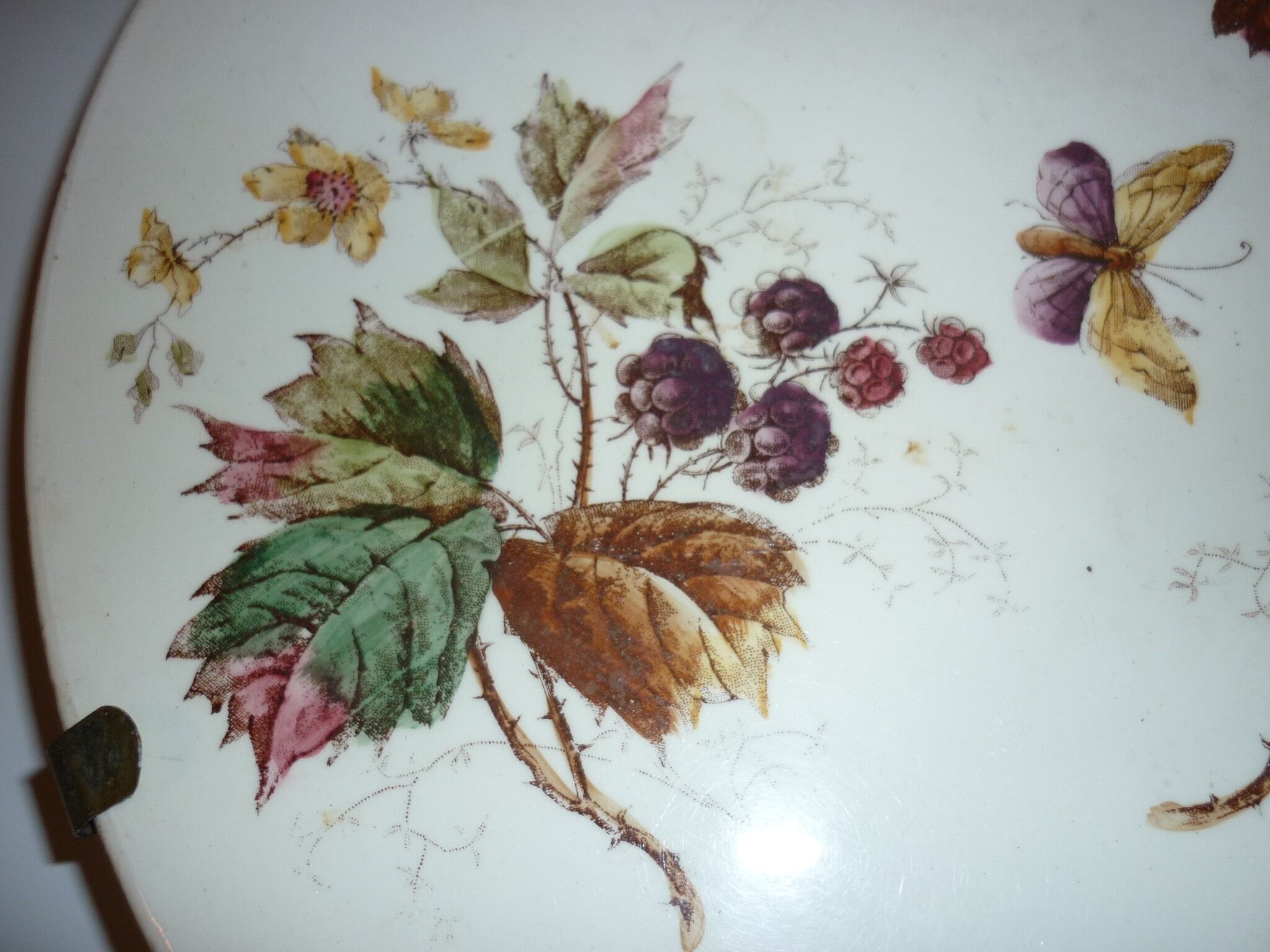 Ceramic plate underside on bronze stand