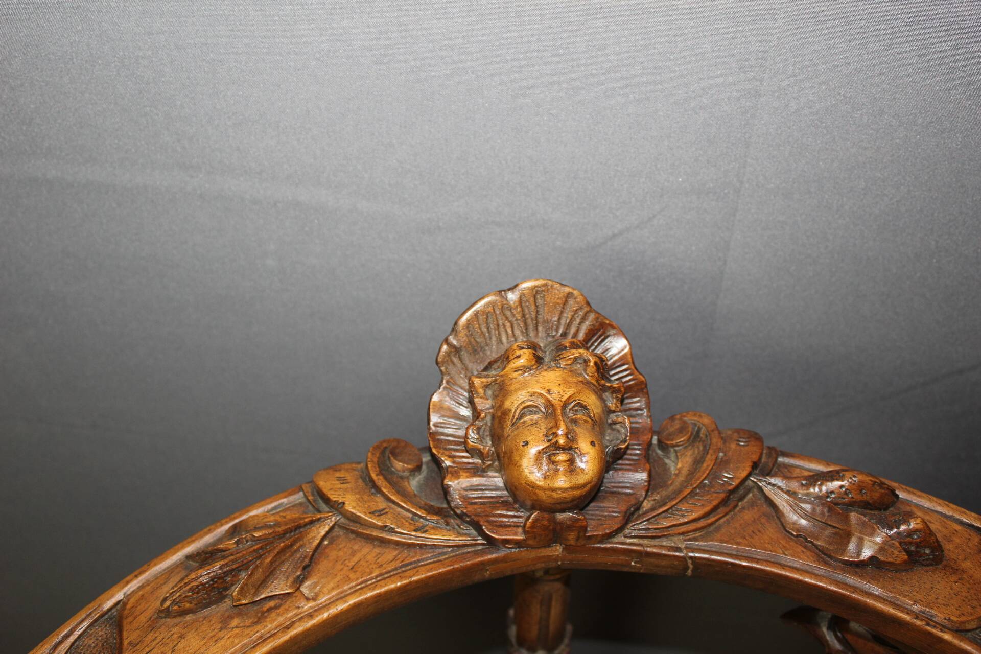 19th century walnut corner armchair with carved angel decoration