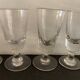 12 old glasses on foot at bistro or absinthe