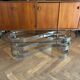 70s design oval coffee table in glass with chrome legs.