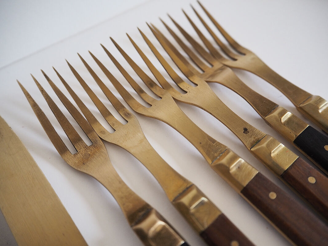 Set of old dessert cutlery in wood and brass