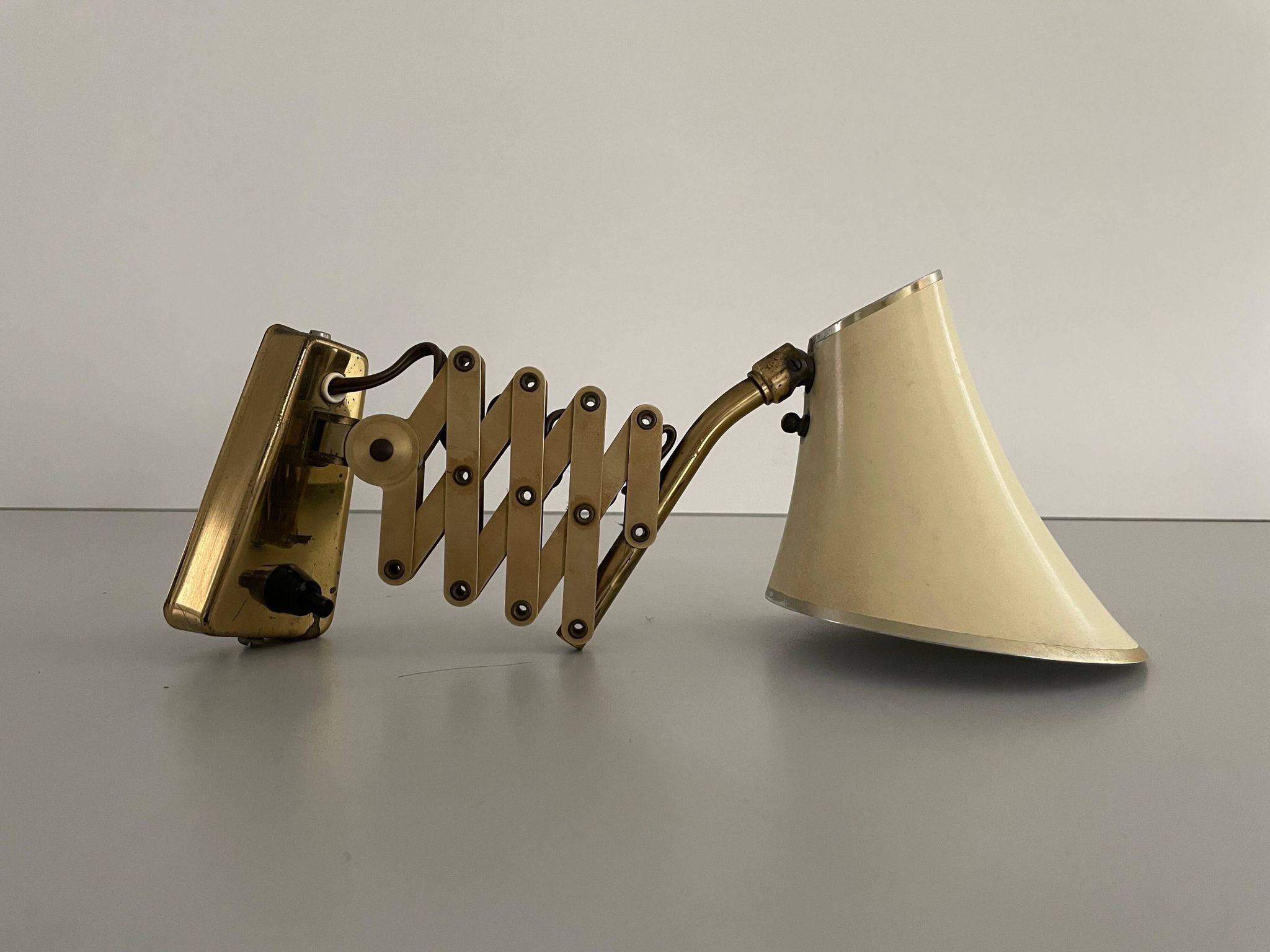 Cream metal and brass wall lamp with scissors design by Karl Lang for SIS Licht, 1950s, Germany.