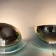 Pair of gold metal and plexiglass wall lights, circa 1980.
