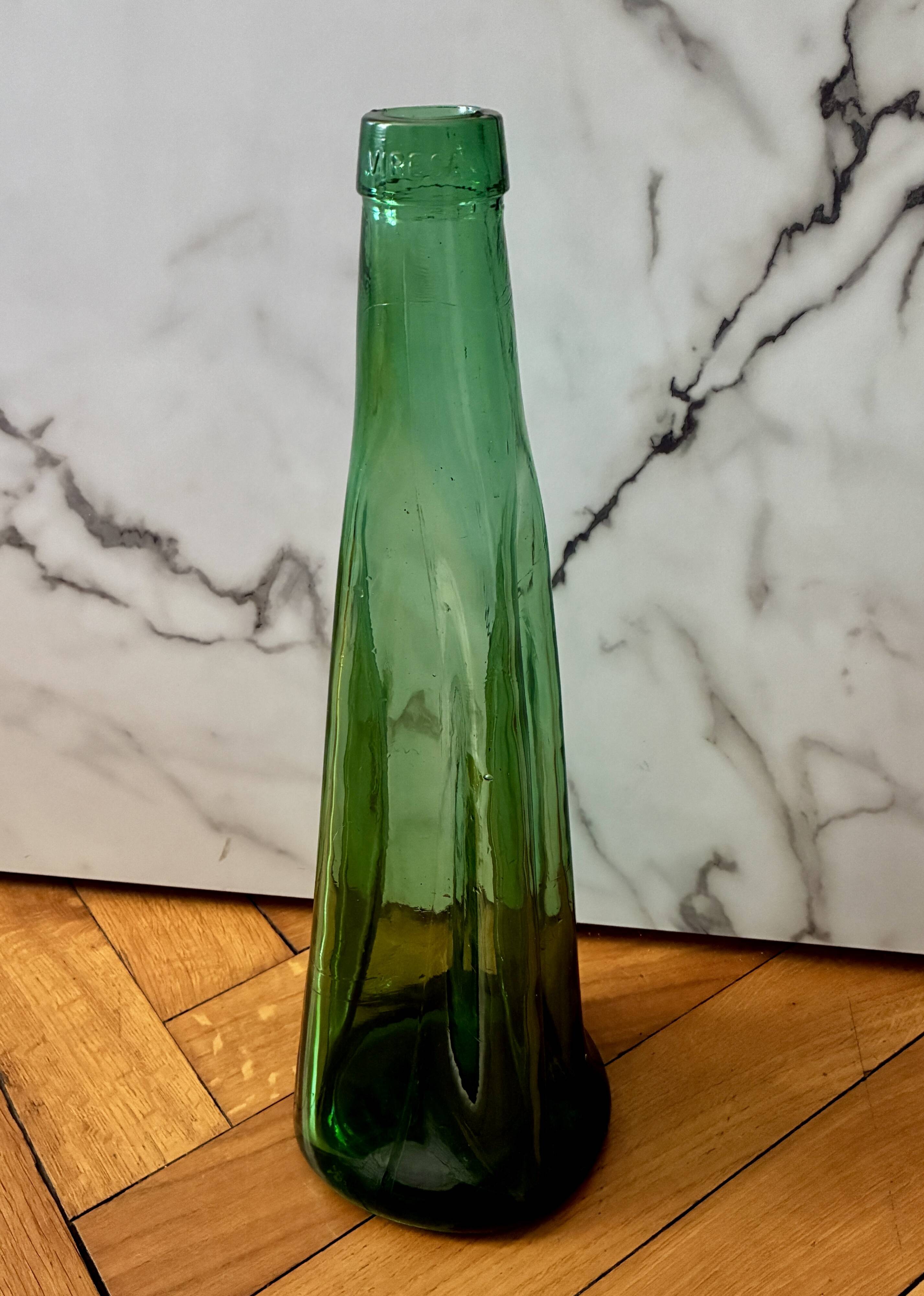 Vintage Viresa bottle in a flattened shape.