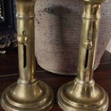 Pair of brass torch candle holders with pushers