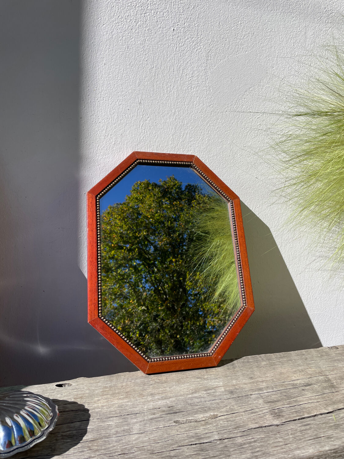 Octagonal beaded wooden mirror