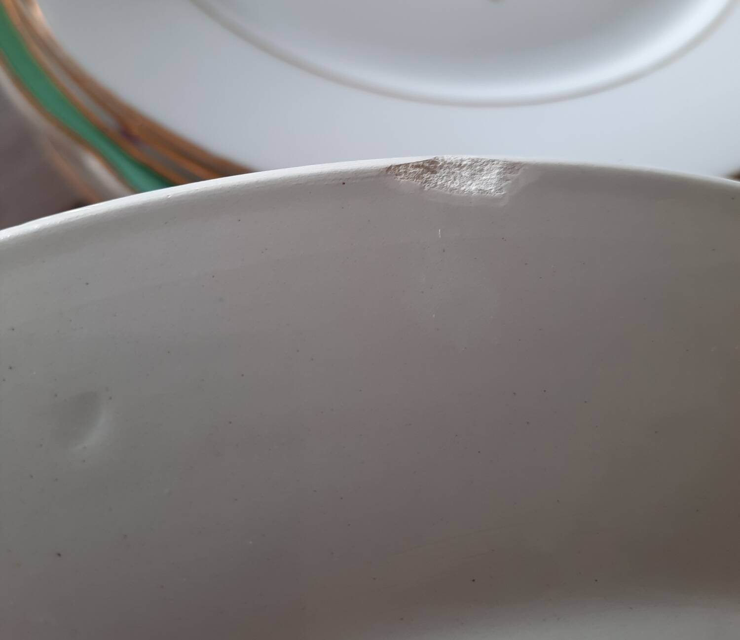Mismatched old soup plates accompanied by a soup tureen
