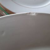 Mismatched old soup plates accompanied by a soup tureen