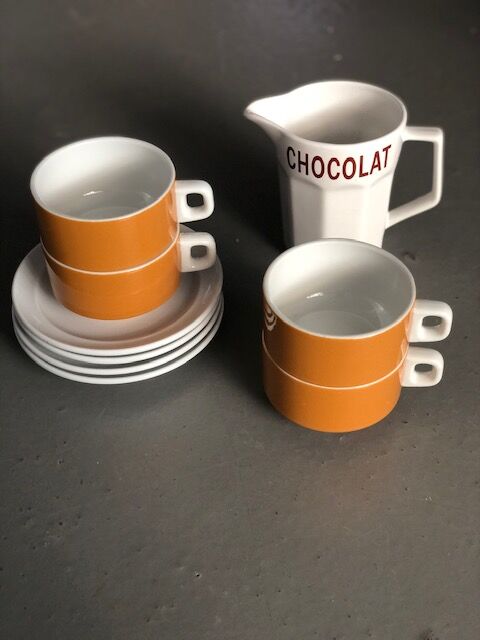 Hot chocolate cups and milk jar
