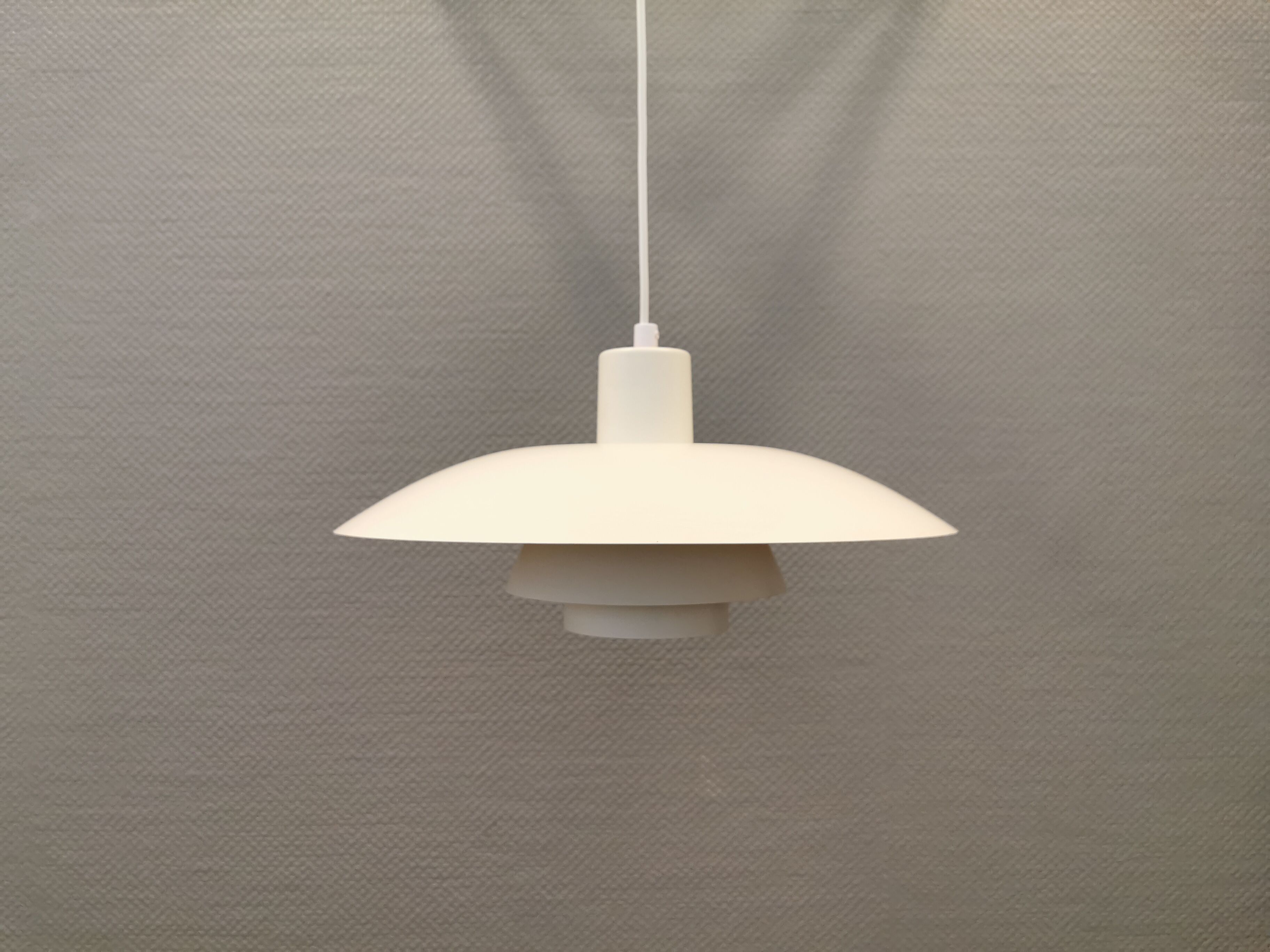 Older ph 4/3 hanging lamp, in white, with original orange suspension disk.