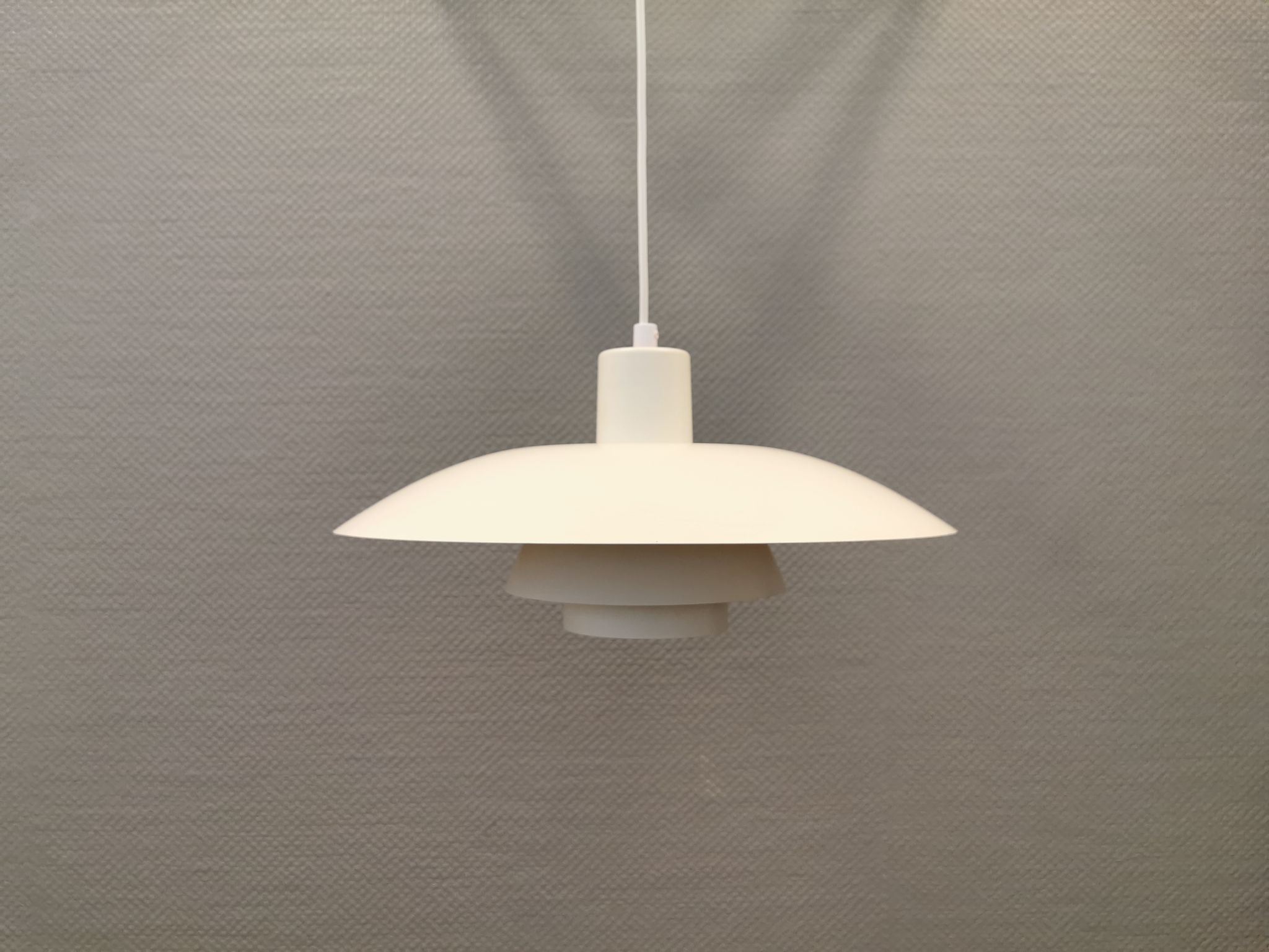 Older ph 4/3 hanging lamp, in white, with original orange suspension disk.