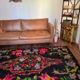 Bohemian floral design, handwoven wool rug, black background with colorful flowers