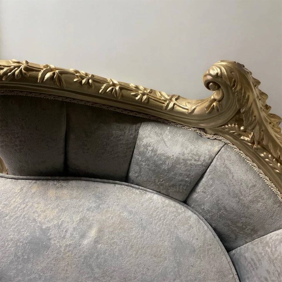 A soft light blue and silver tufted beech wood sofa in Louis style.