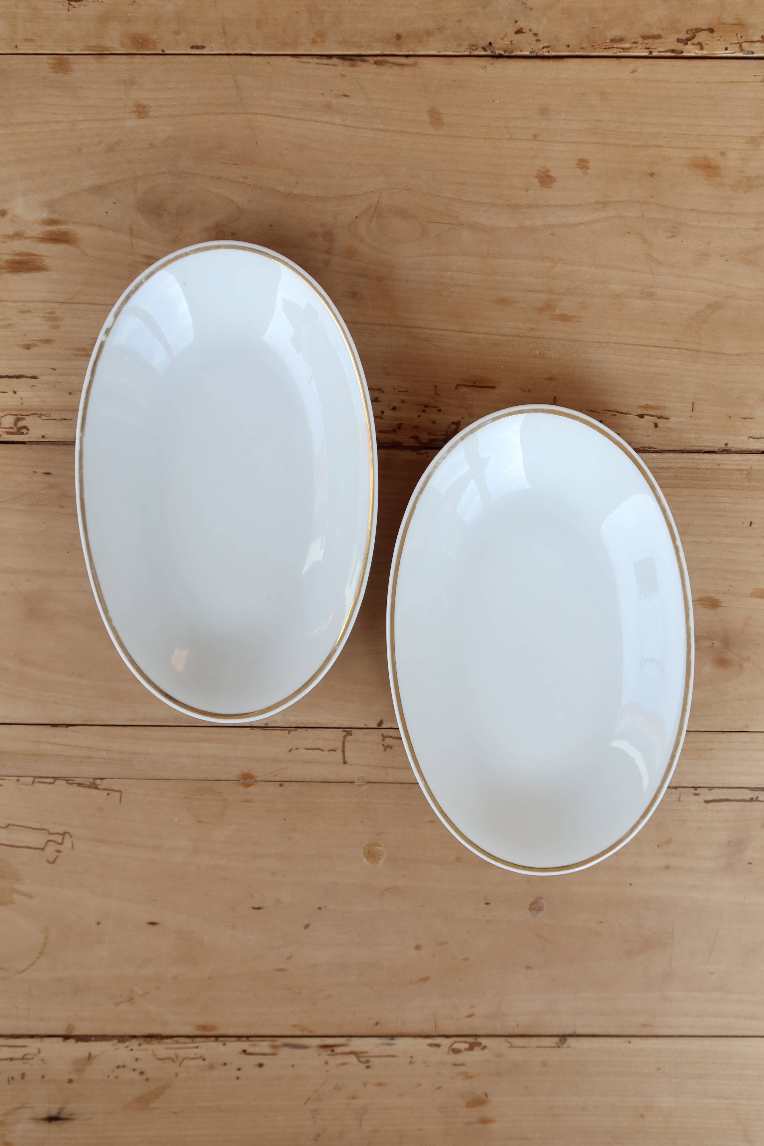 Vintage white porcelain trays with a golden rim.