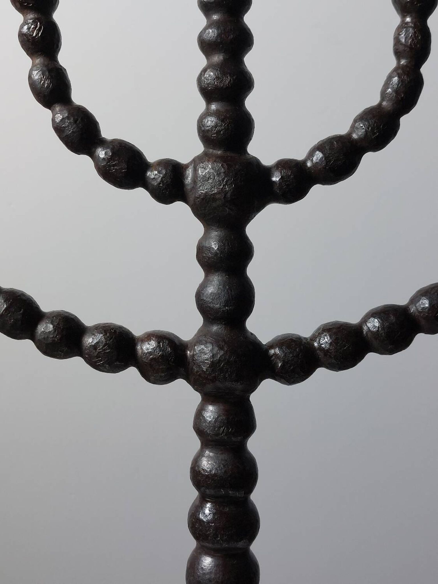 Candelabrum in the shape of a spool, skilfully forged in menorah style.