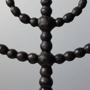 Candelabrum in the shape of a spool, skilfully forged in menorah style.