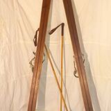 pair of vintage wooden Skis and their bats.