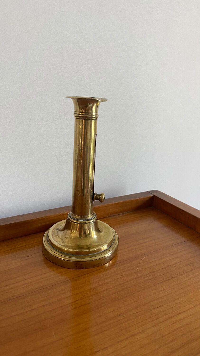 Old brass push candle holder
