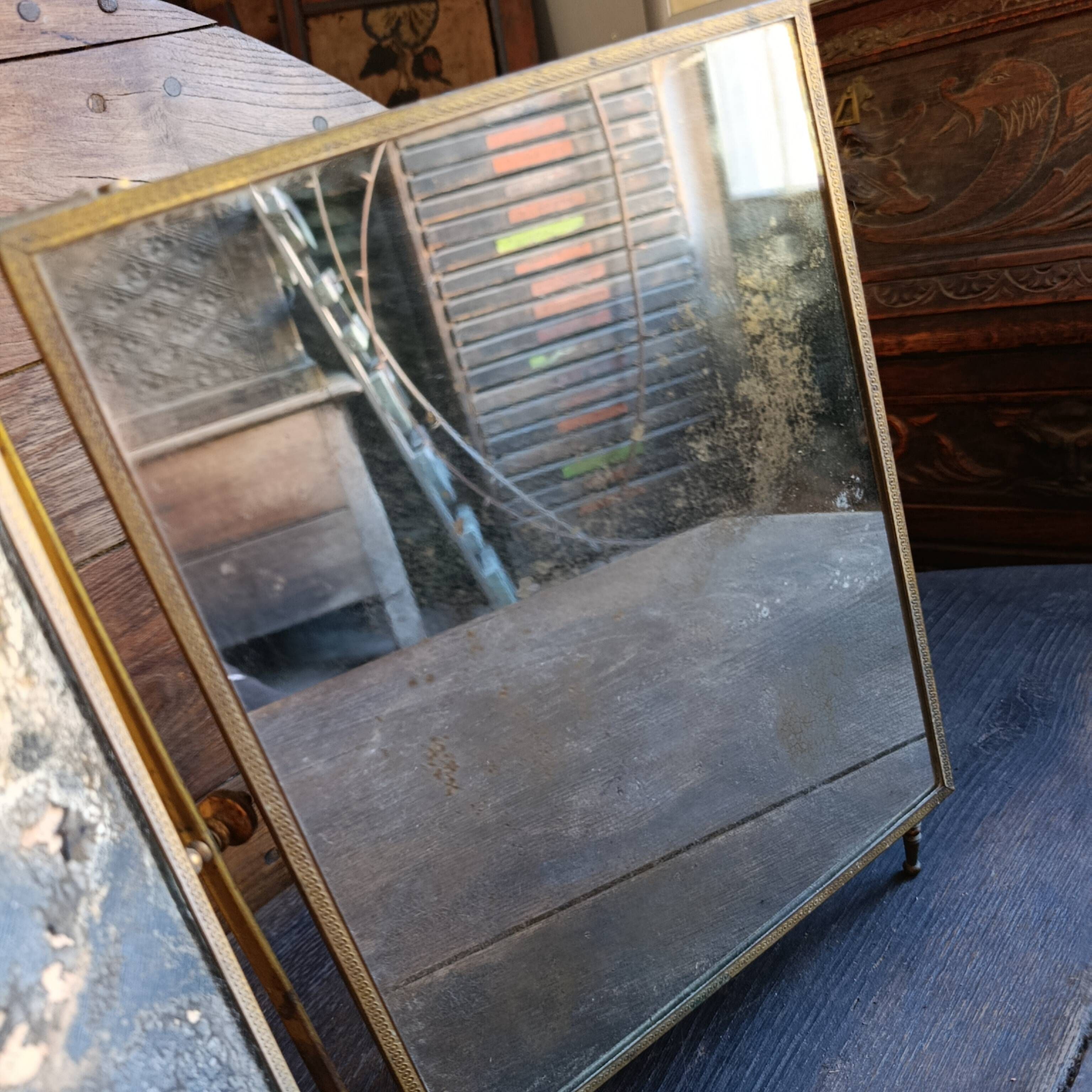 Antique French gilt metal triptych vanity mirror with floral crest