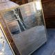 Antique French gilt metal triptych vanity mirror with floral crest
