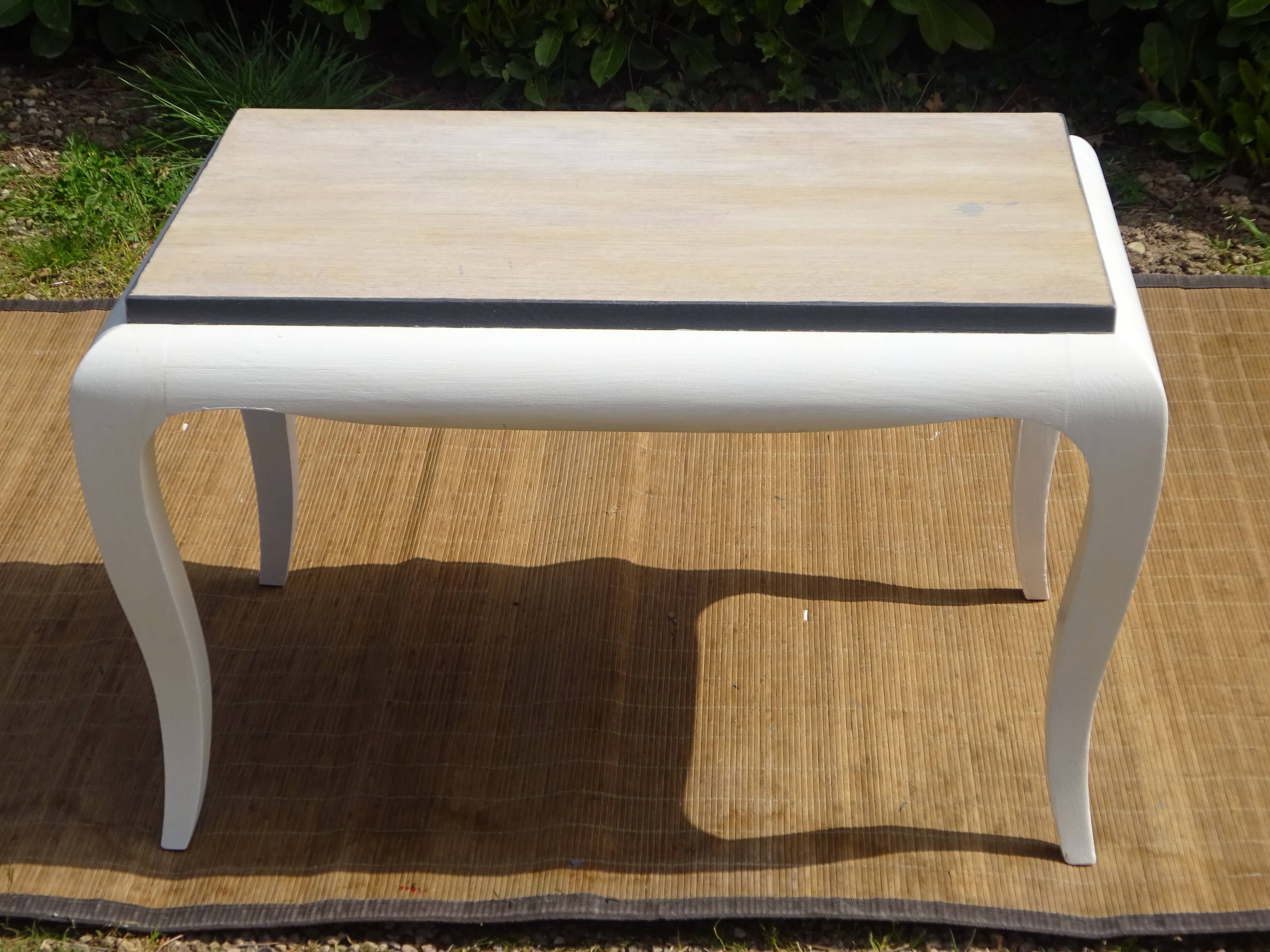 Oak coffee table with curved legs.