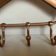 Coat rack gilded metal hanger varnished