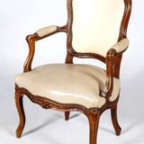 Louis XV period armchair in natural wood with convertible back carved with flowers