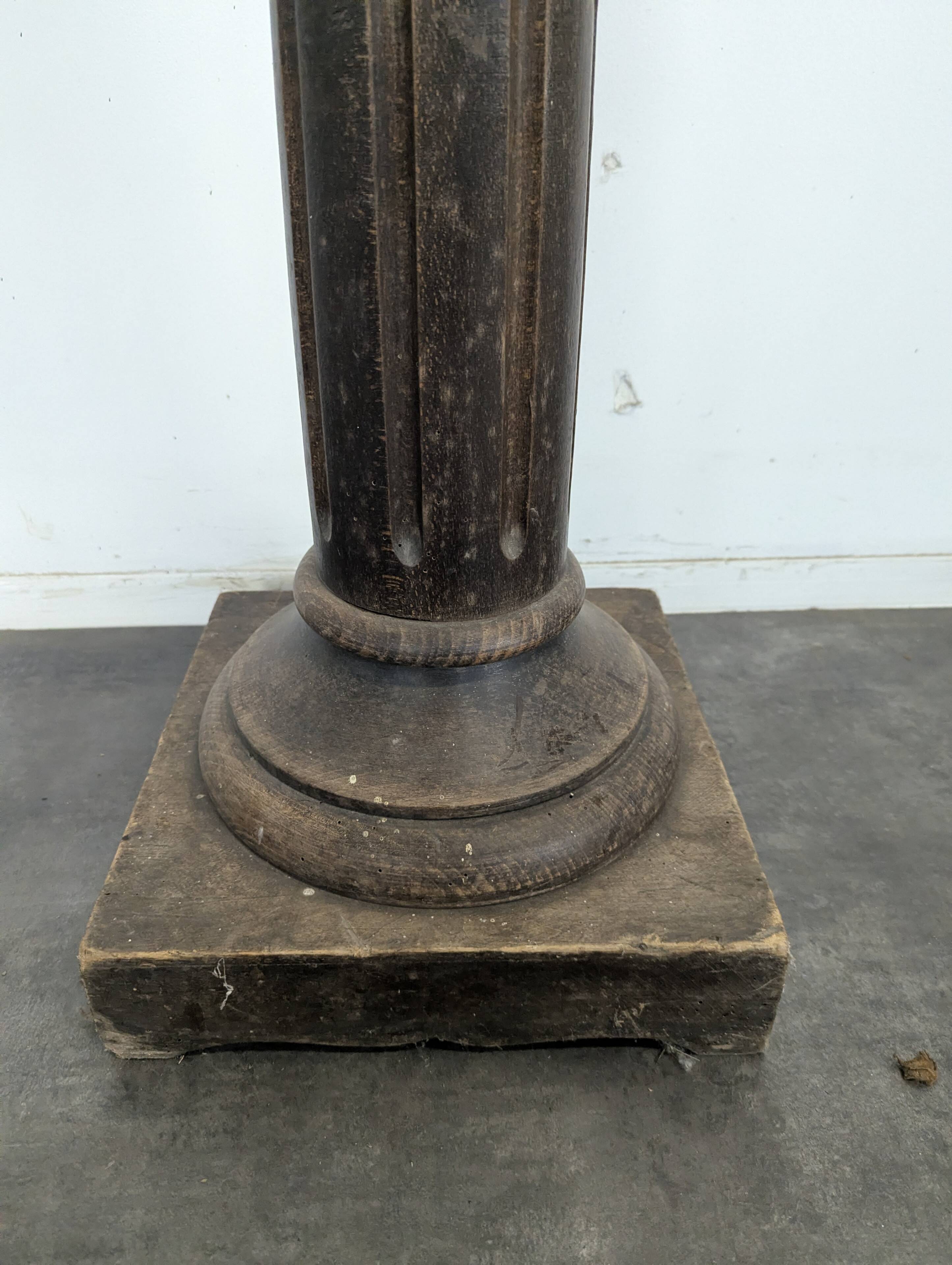 Fluted column side table in oak with a square top.