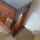 Empire/Restoration style console table with scrolled ends, mirrored back, and claw feet.