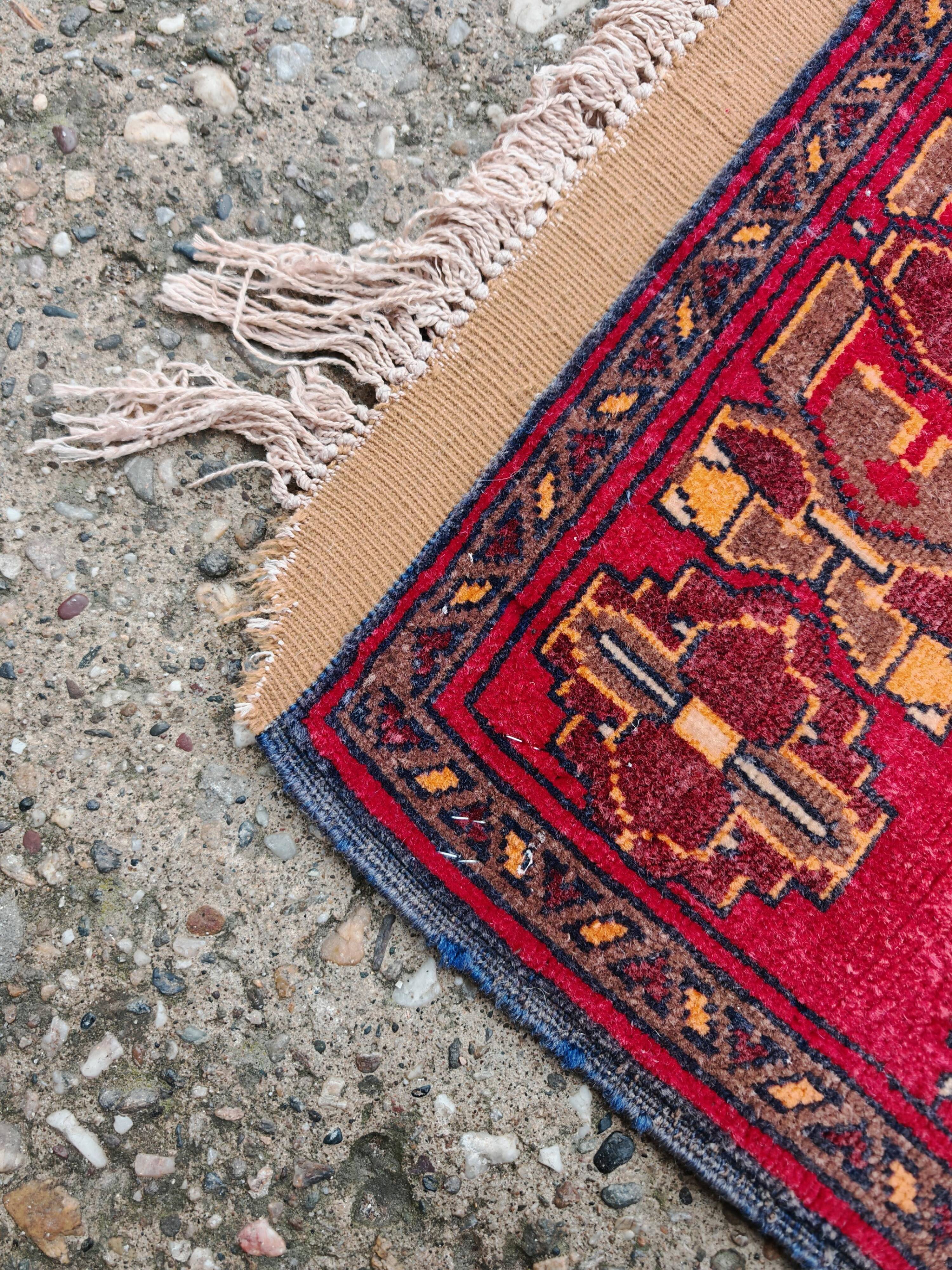 Vintage Afghan hand-knotted prayer rug with Islamic patterns.